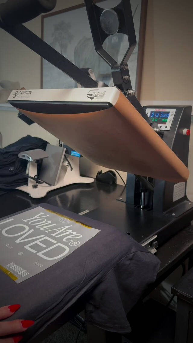 Pressing a You Are Loved tee